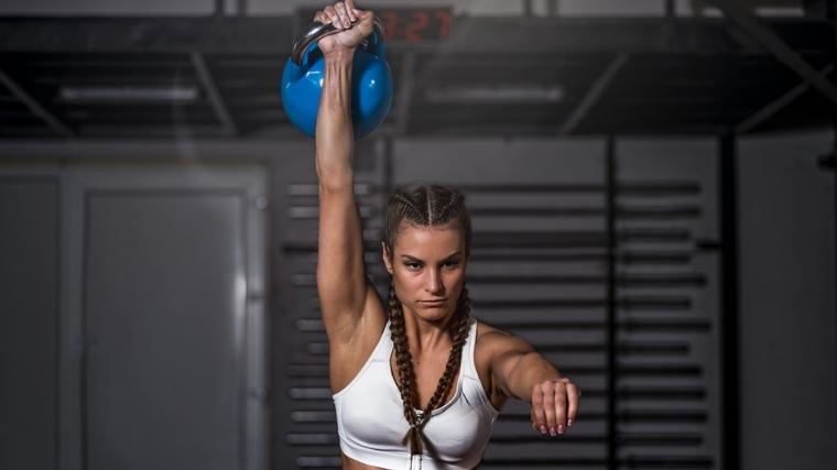 Woman doing kettlebell snatch