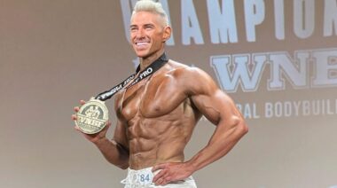 Bodybuilder Chris Elkins posing on stage