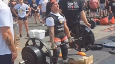 Strongwoman Kira Wrixon performing heavy barbell deadlift