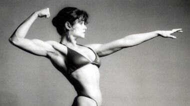 Bodybuilder Lisa Lyon posing and flexing muscles