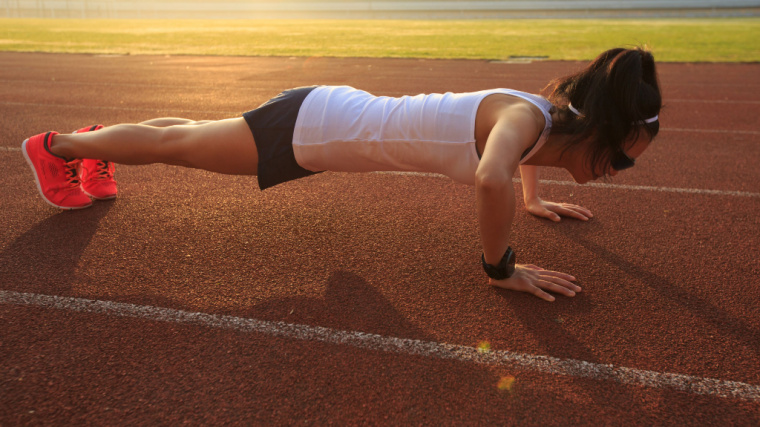 person outdoors performing push-ups